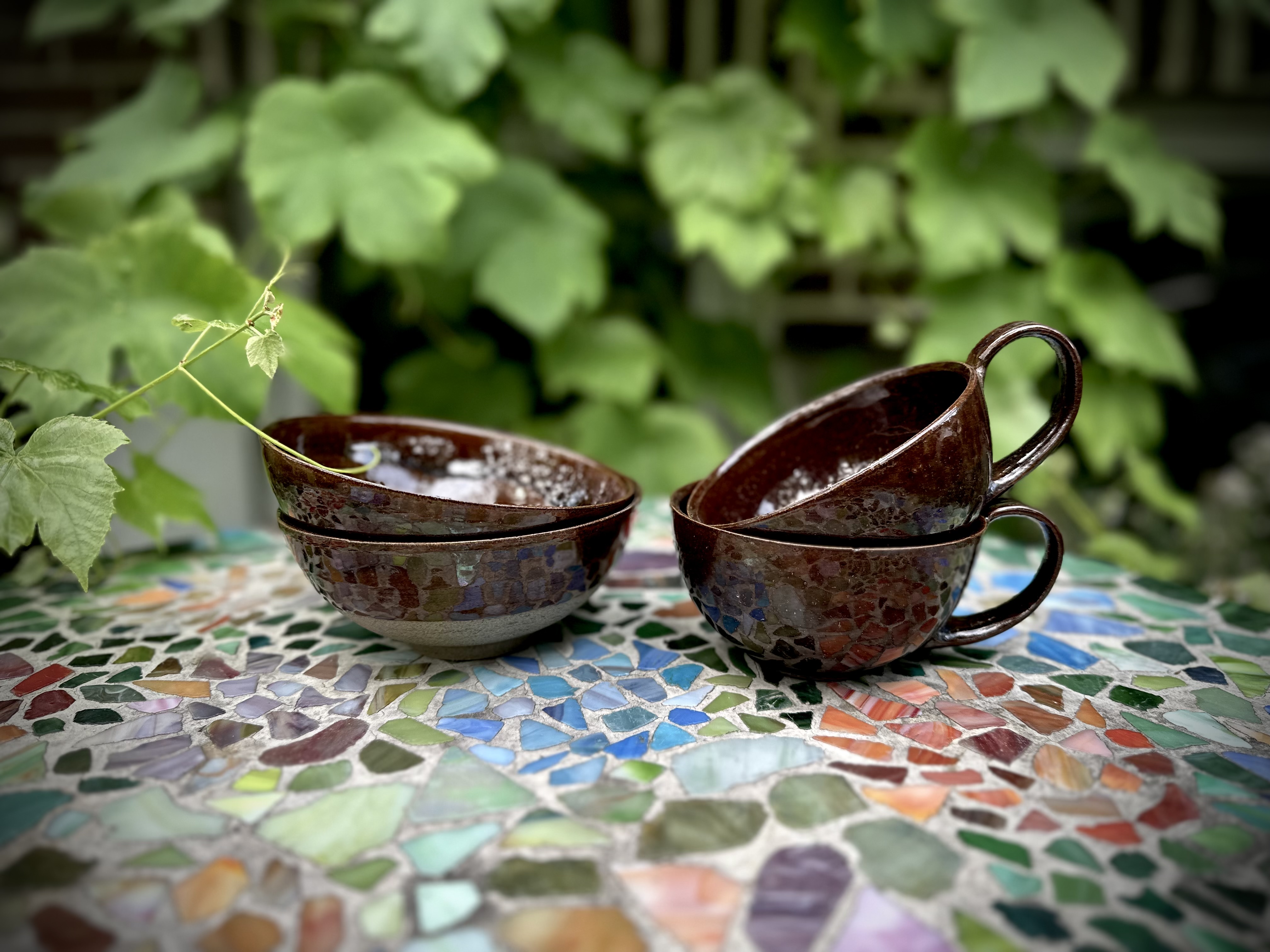 Stoneware cups in earthy glazes.