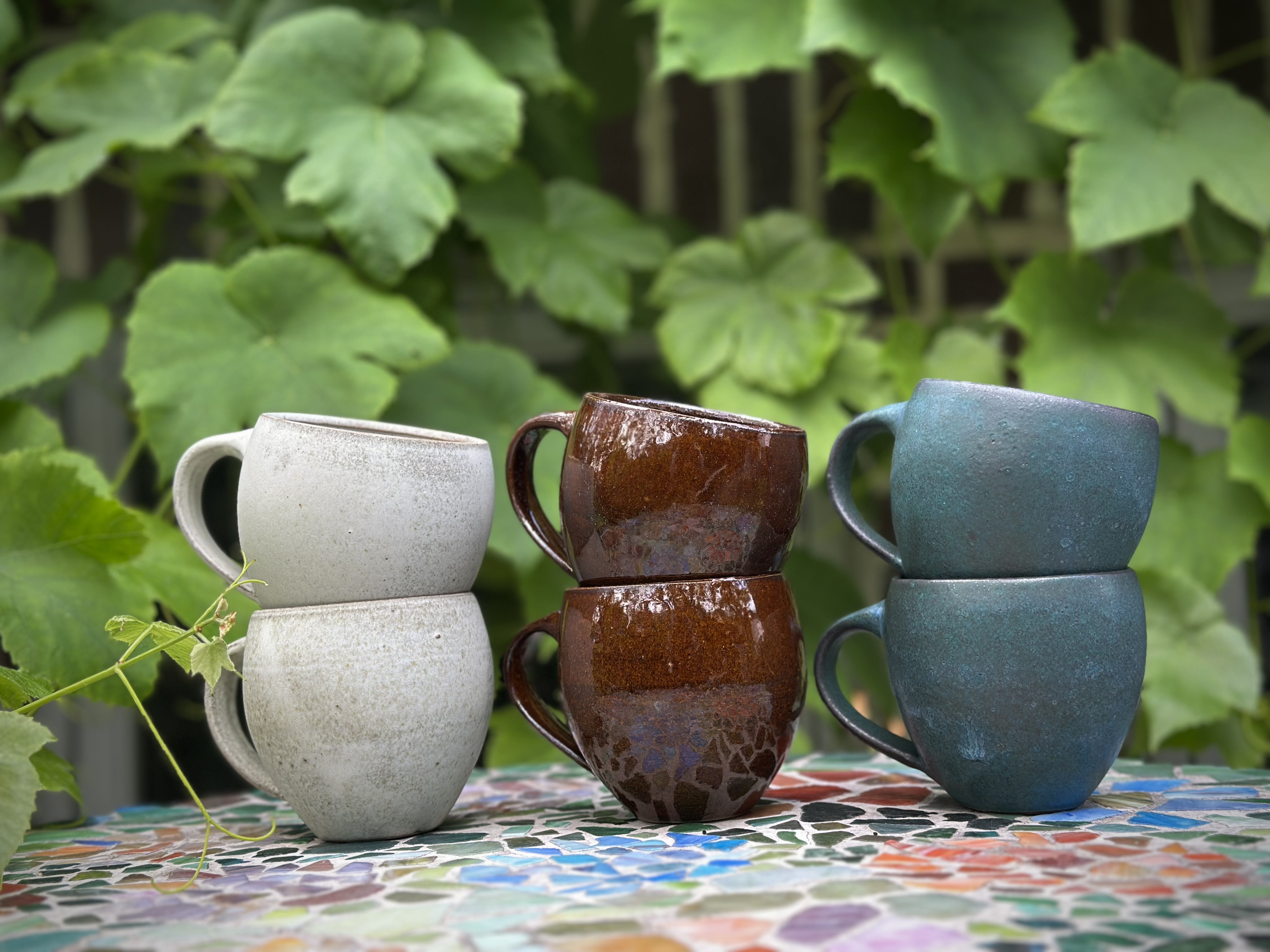 Handmade ceramic cups with colourful glazes.