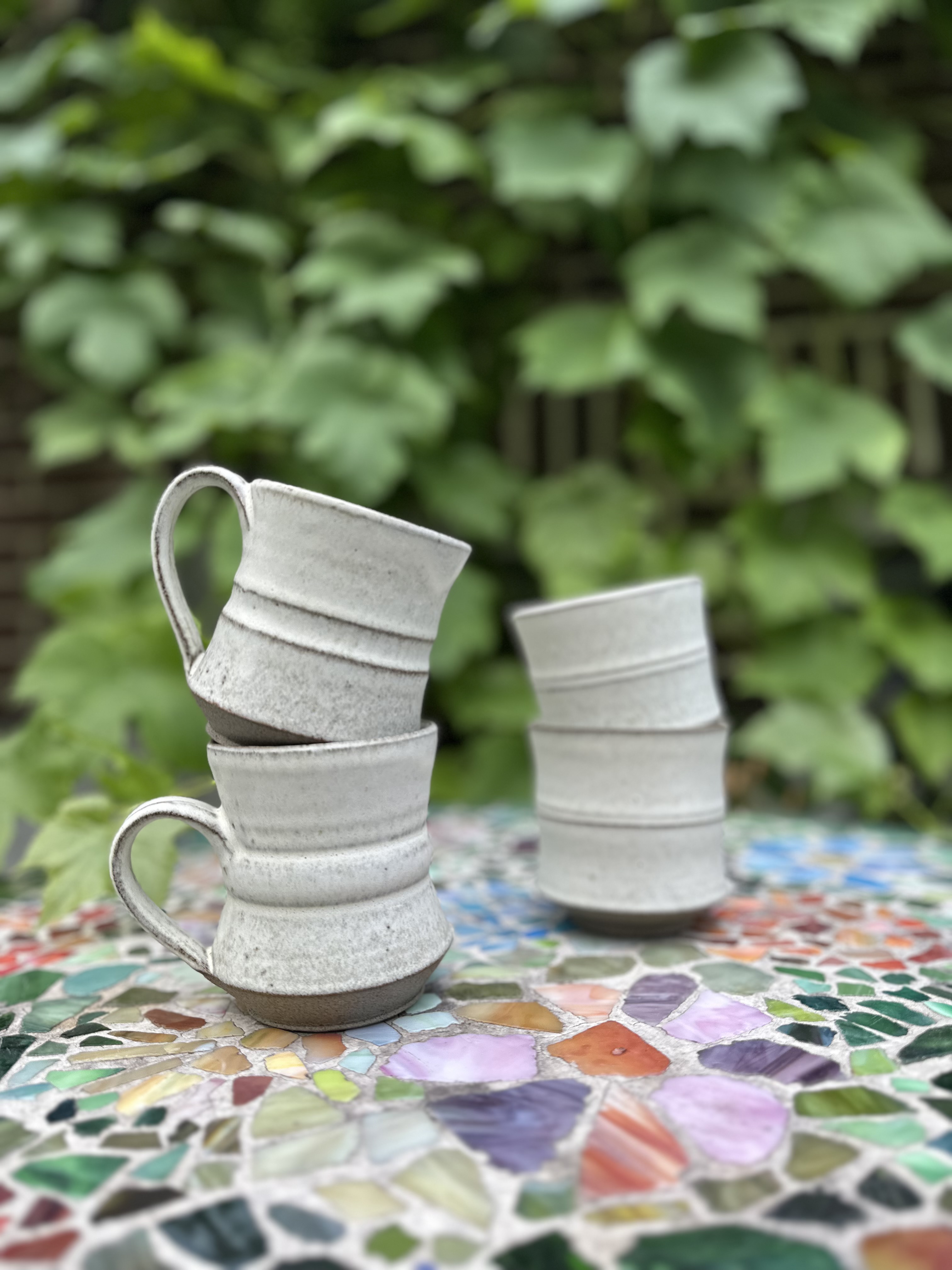 Handmade ceramic cups with a light glaze.