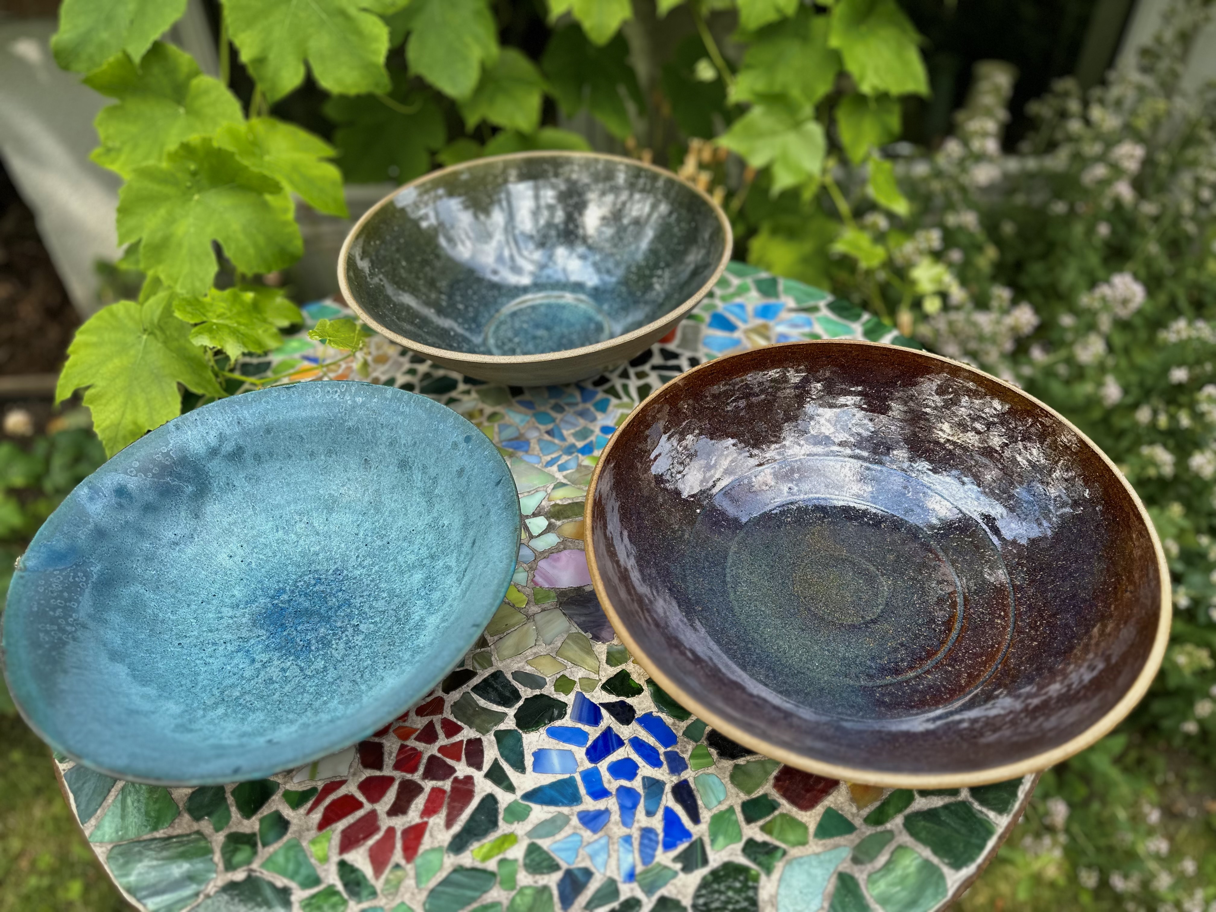 Handmade ceramic platters in natural glazes.